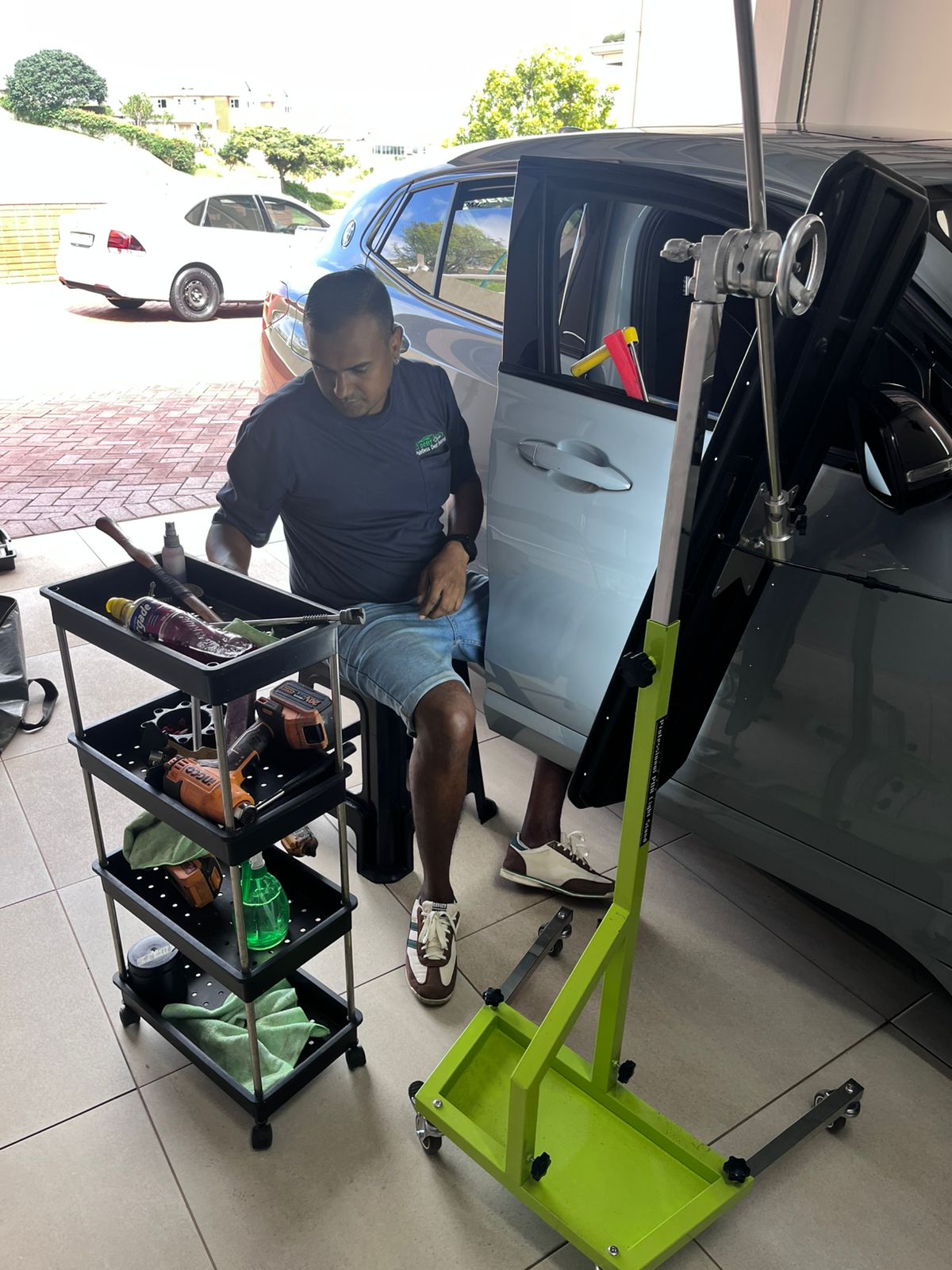 Wesley Chetty performing dent removal with professional tools and full equipment setup